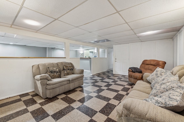 living room with a paneled ceiling