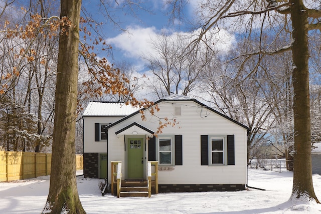 view of front of property featuring crawl space and fence