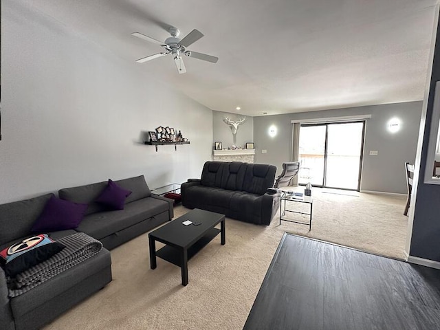 living room with a ceiling fan, light colored carpet, and baseboards