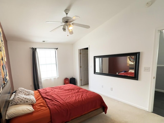 carpeted bedroom with ceiling fan and vaulted ceiling