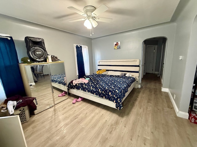 bedroom with ceiling fan and light wood-type flooring