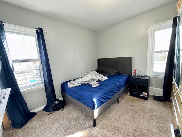 bedroom featuring light colored carpet