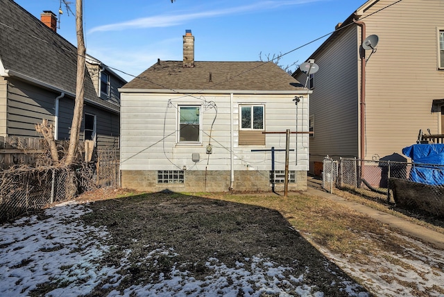 view of snow covered rear of property