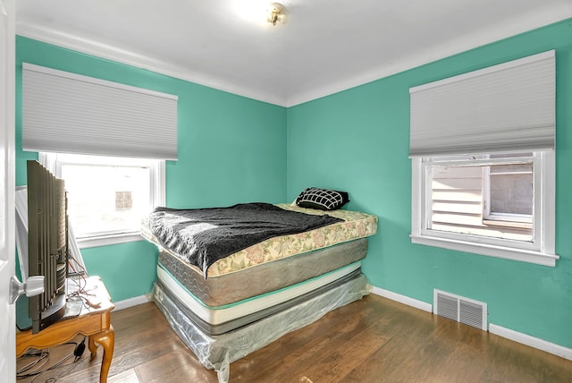 bedroom with dark wood-type flooring