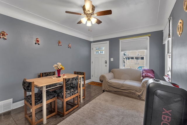 tiled living room featuring ceiling fan