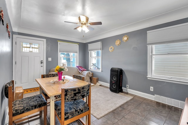 dining room featuring dark tile patterned floors and ceiling fan