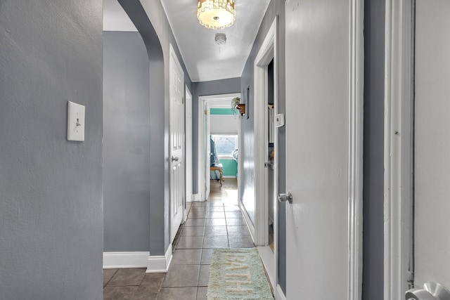 corridor featuring dark tile patterned flooring