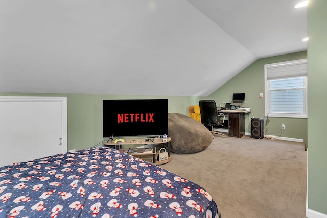 bedroom featuring lofted ceiling and carpet