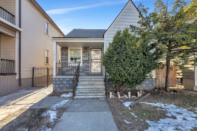 view of exterior entry with covered porch