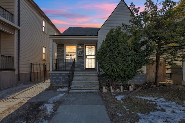 view of exterior entry at dusk