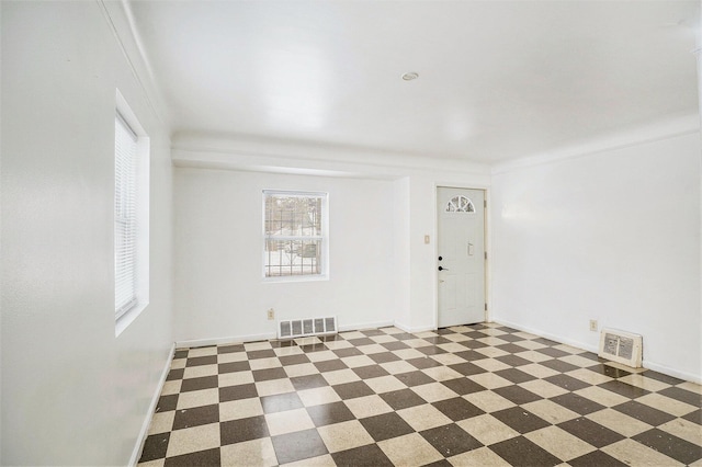 spare room featuring crown molding