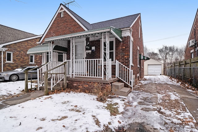 view of front of home with a garage and an outdoor structure