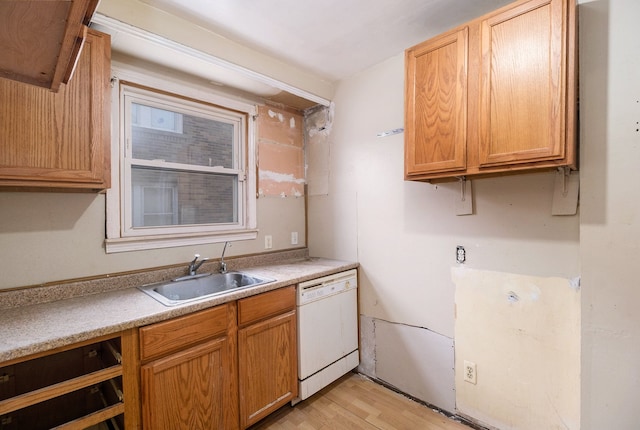 kitchen with dishwasher, sink, and light hardwood / wood-style floors