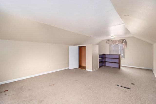 bonus room featuring lofted ceiling and carpet