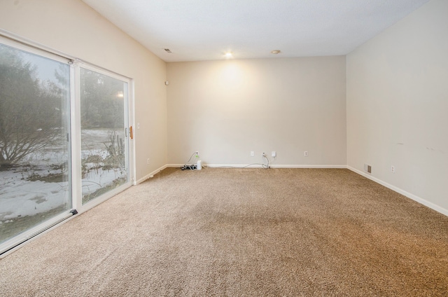 empty room featuring carpet flooring and baseboard heating