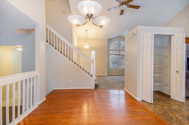 interior space with lofted ceiling, wood-type flooring, and ceiling fan