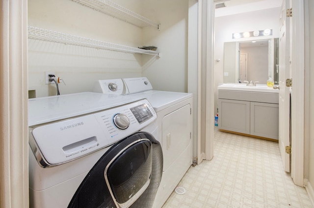 clothes washing area featuring sink and washing machine and clothes dryer