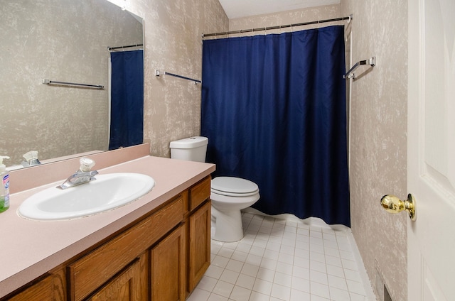 bathroom featuring tile patterned floors, vanity, and toilet