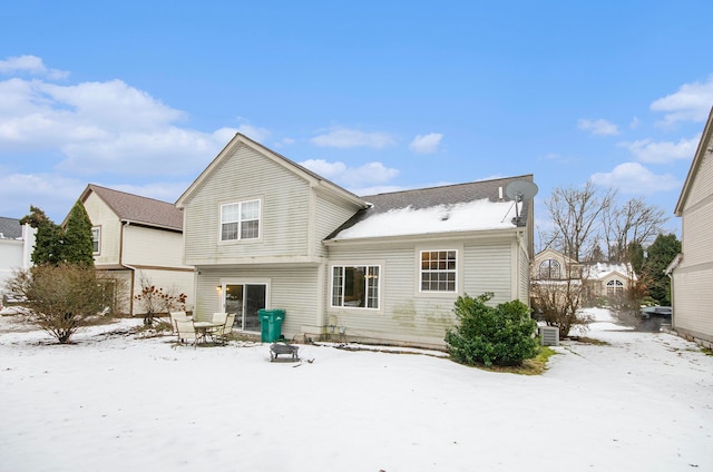 view of snow covered rear of property