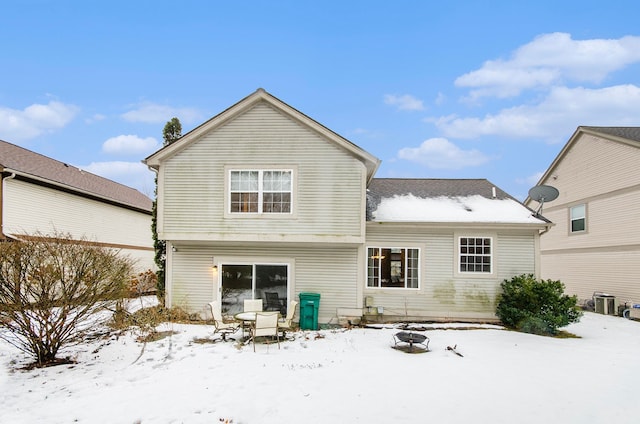 view of snow covered back of property