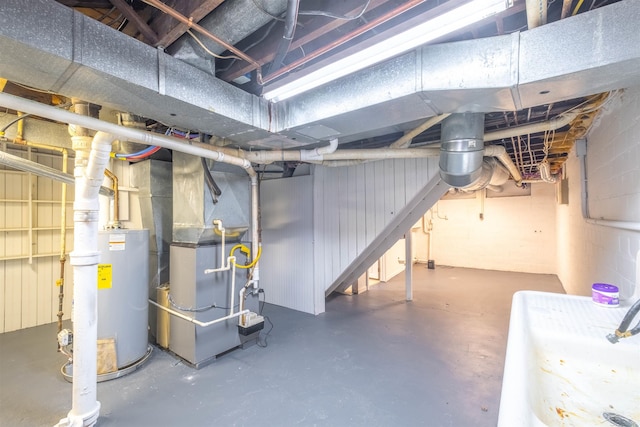 basement featuring heating unit and water heater