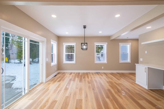 unfurnished dining area featuring light hardwood / wood-style flooring