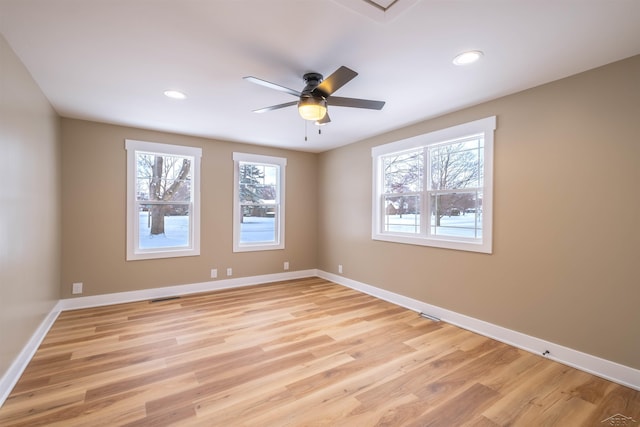 spare room featuring ceiling fan and light hardwood / wood-style flooring