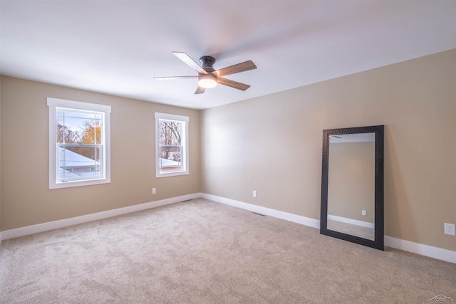 empty room featuring light carpet and ceiling fan