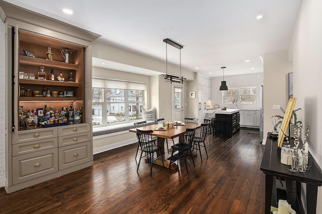 dining area with dark hardwood / wood-style flooring