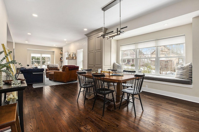 dining area featuring dark wood-type flooring