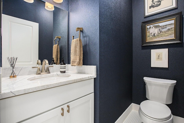 bathroom featuring tile patterned floors, vanity, and toilet