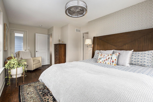 bedroom with dark hardwood / wood-style flooring