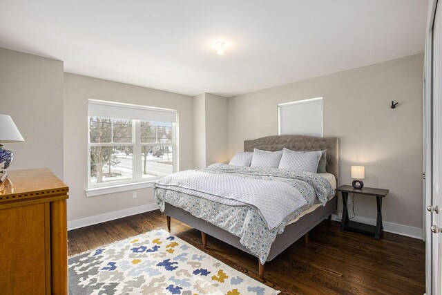 bedroom with dark hardwood / wood-style floors