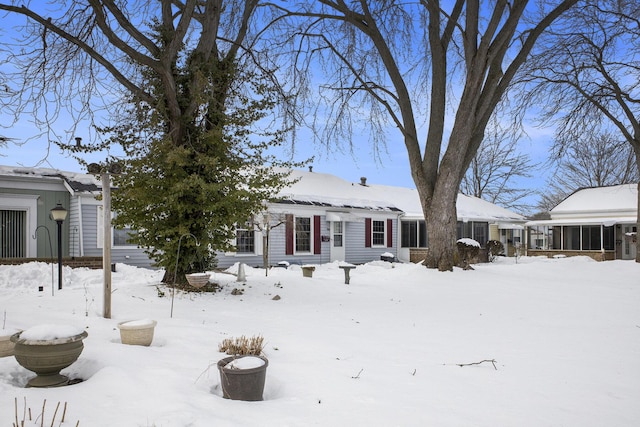 view of snow covered back of property