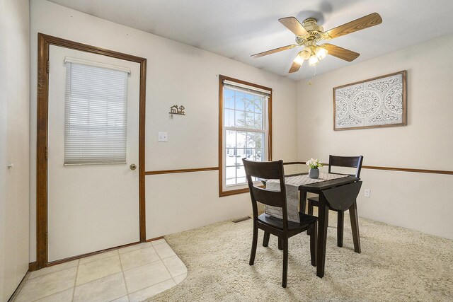 dining area with light tile patterned floors and ceiling fan