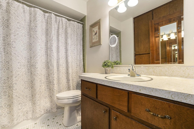 bathroom featuring vanity, toilet, and tile patterned flooring