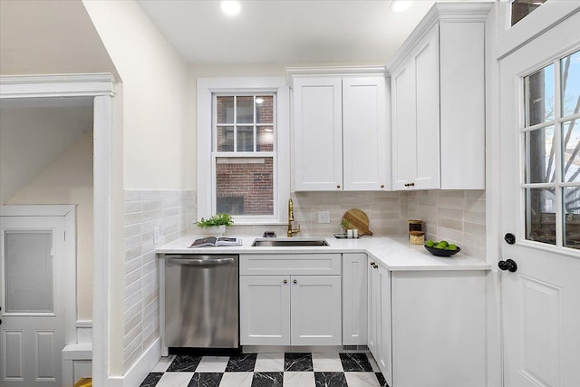 kitchen featuring sink, stainless steel dishwasher, and white cabinets