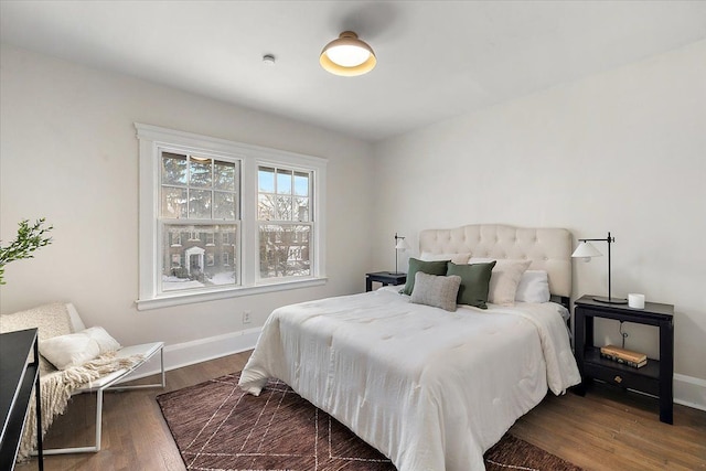 bedroom with dark wood-type flooring