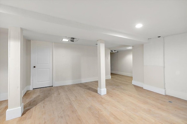 basement with light hardwood / wood-style floors