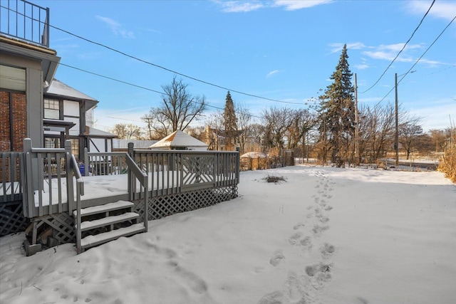 snowy yard with a wooden deck