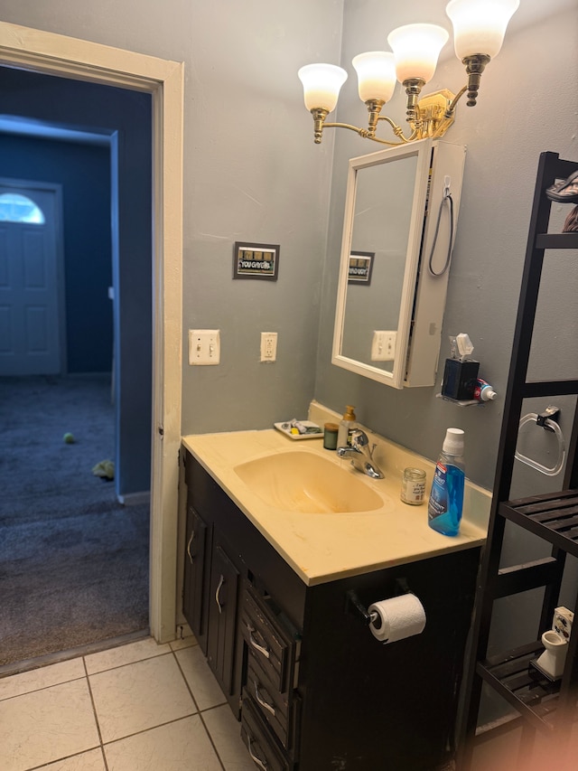 bathroom featuring tile patterned floors, vanity, and a chandelier