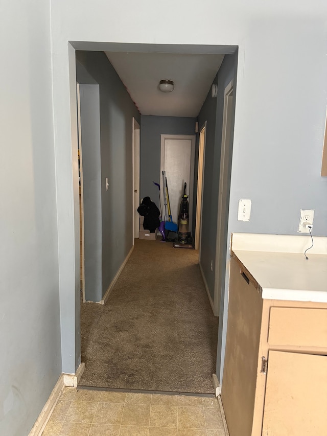 hallway featuring light colored carpet