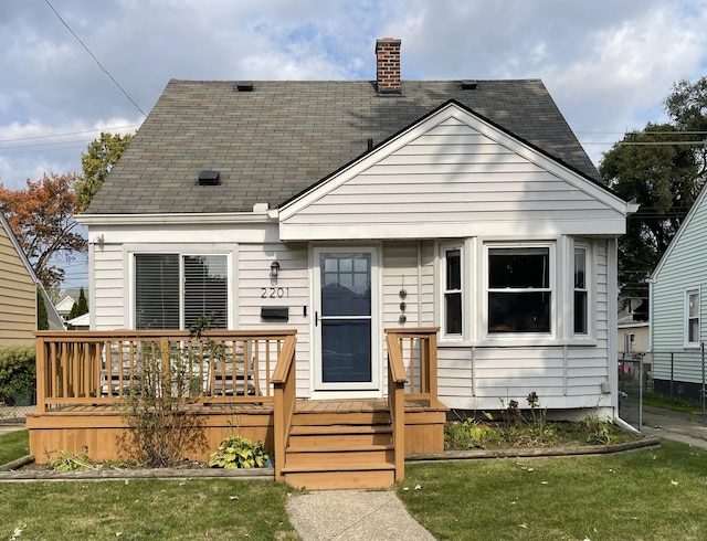 bungalow-style home featuring a front yard