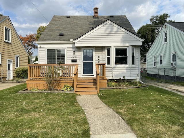 bungalow-style home featuring cooling unit and a front yard