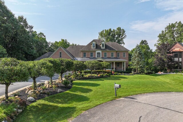 8557 Forestview Dr, Canton, MI 48187 - view of front of property with a front lawn, a standing seam roof, a porch, and metal roof