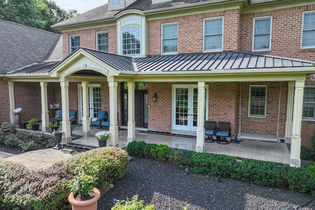 8557 Forestview Dr, Canton, MI 48187 - view of front of property featuring french doors, a standing seam roof, brick siding, and a shingled roof