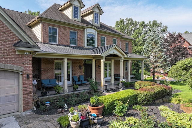8557 Forestview Dr, Canton, MI 48187 - view of front of home featuring a porch, brick siding, french doors, and a garage