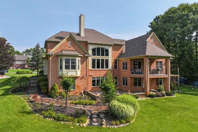 8557 Forestview Dr, Canton, MI 48187 - back of property featuring a balcony, brick siding, a chimney, and a lawn