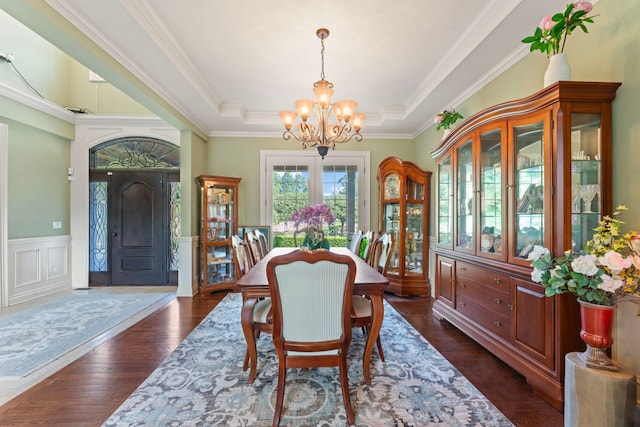 8557 Forestview Dr, Canton, MI 48187 - dining area with a chandelier, a tray ceiling, ornamental molding, a wainscoted wall, and dark wood-style floors