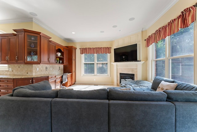 living room with ornamental molding and a fireplace